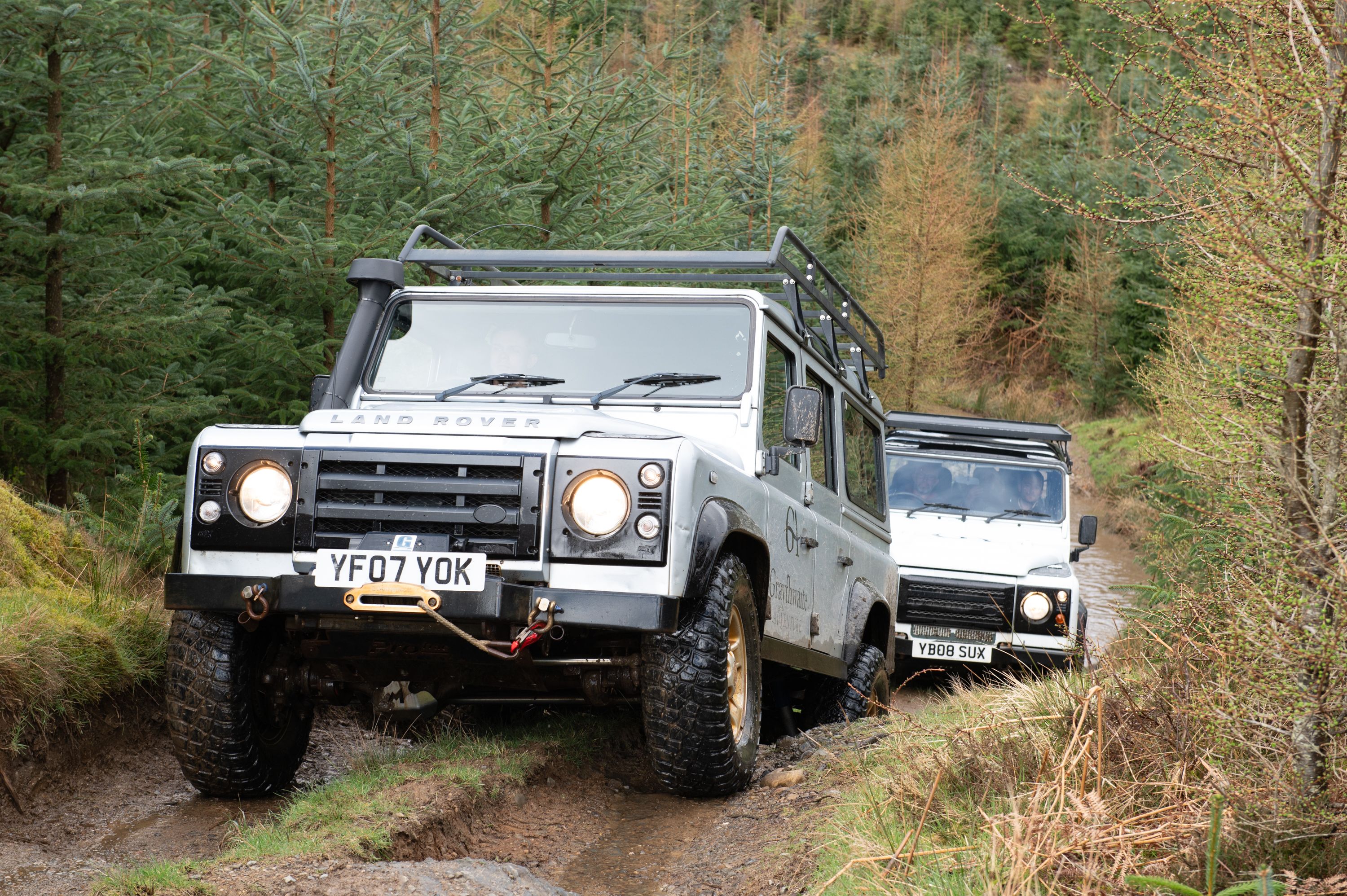 Land Rover's driving through the countryside