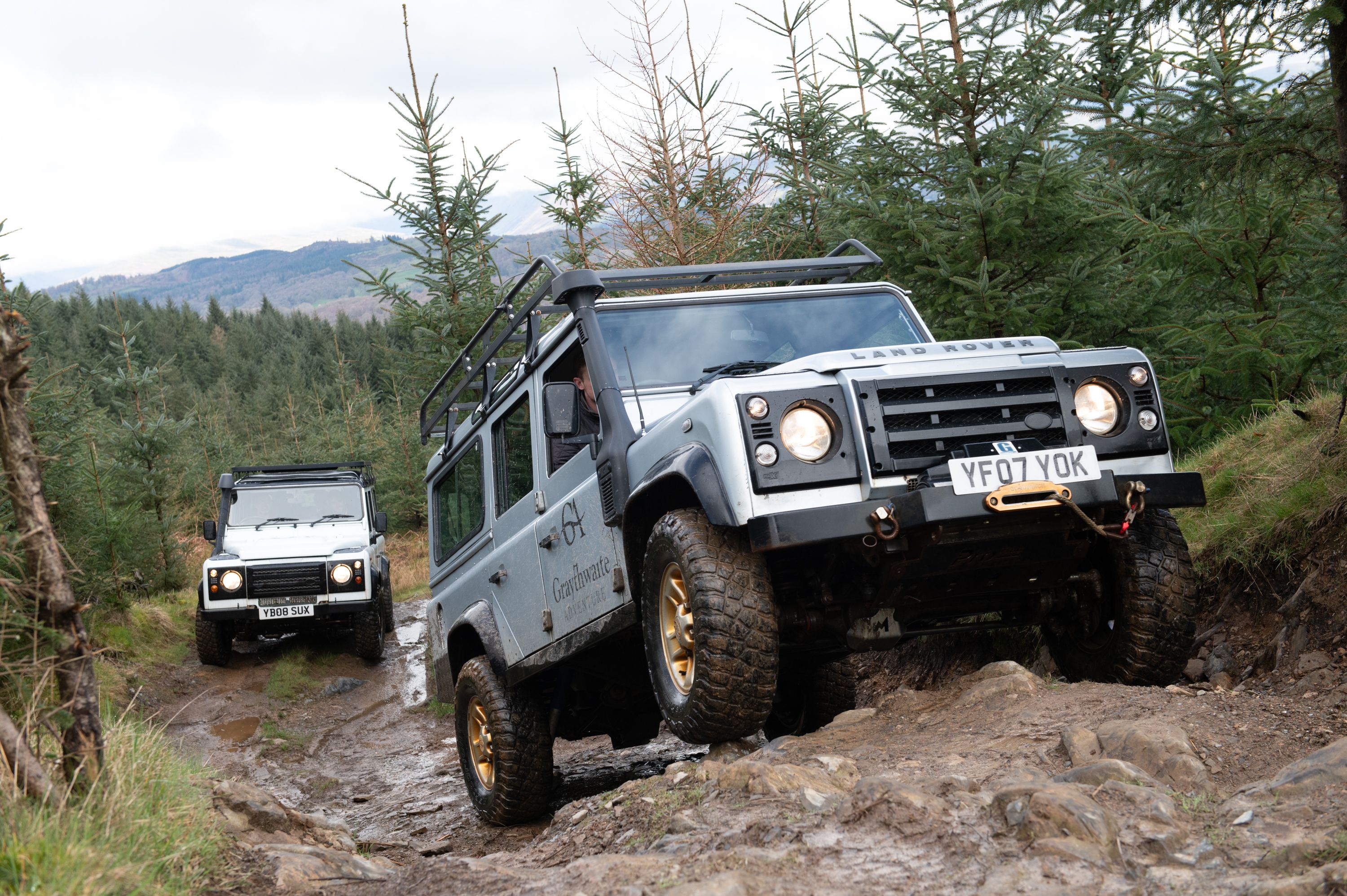 Land Rover's driving through the countryside