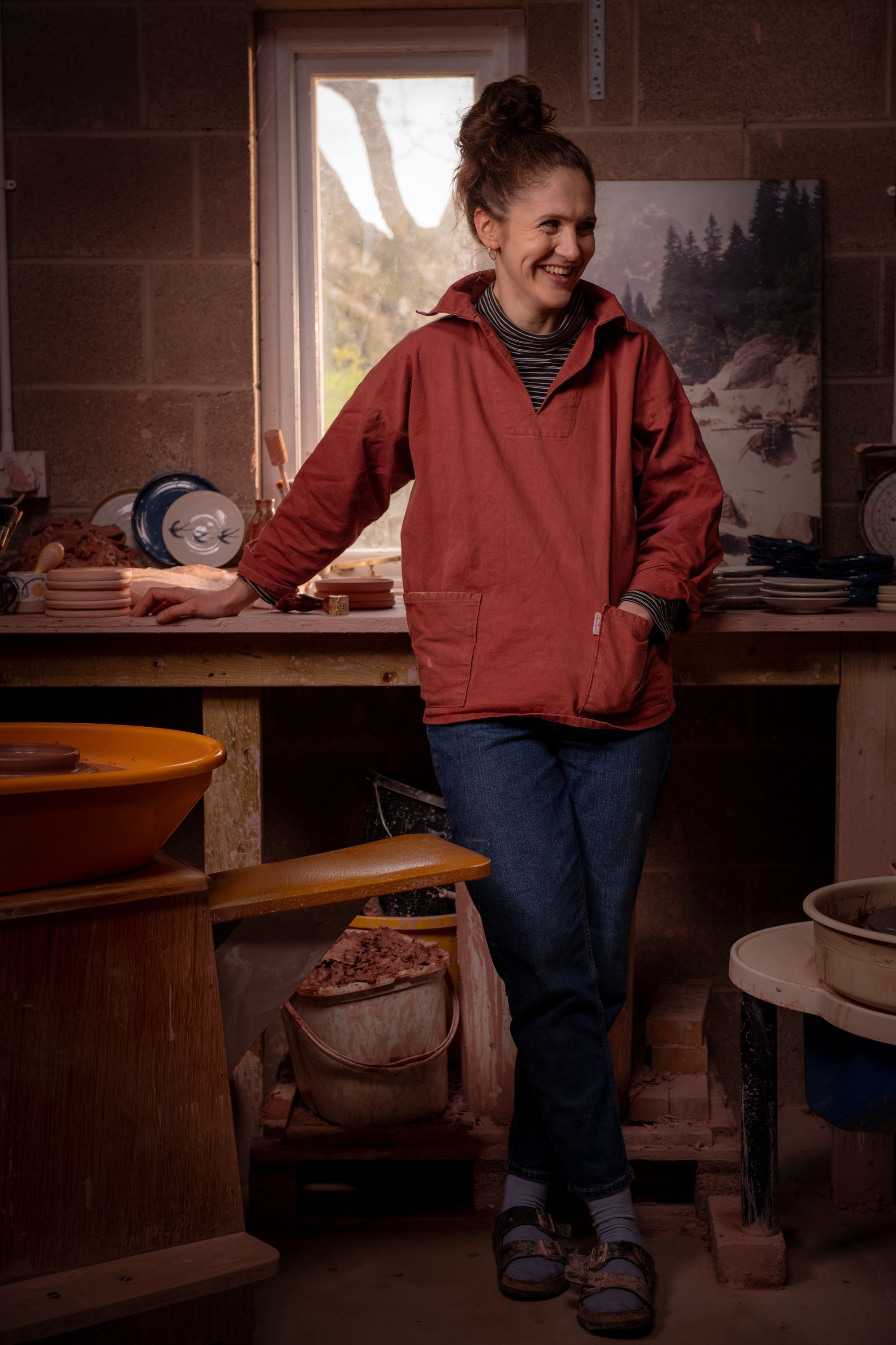 A potter standing in her workspace